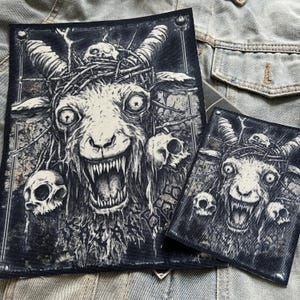 May include: Black and white embroidered patch depicting a demonic goat with horns, a crown of thorns, and a snarling expression. The goat is surrounded by skulls and thorns.