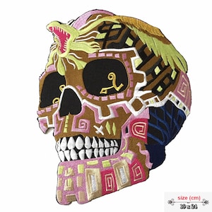 May include: Embroidered patch of a colorful skull with intricate designs. The skull is brown with pink, white, and yellow details. The skull has a snake on top of its head. The patch is 19 inches by 24 inches.