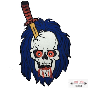 May include: Embroidered patch featuring a skull with a knife through its head. The skull has red eyes and a blue mohawk. The patch is 15 x 25 cm.