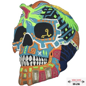 May include: A colorful embroidered skull patch with a green dragon on top. The skull is decorated with intricate patterns in orange, blue, green, and white. The patch is 19 inches by 24 inches.