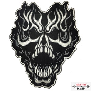 May include: Black and white embroidered patch of a skull with flames. The skull is outlined in white and has a black background. The patch is 24 cm by 29 cm.