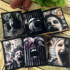 Könnte beinhalten: Sechs rechteckige Aufnäher mit Horror-Illustrationen. Die Bilder zeigen schreiende Gesichter mit offenem Mund, Blut und beunruhigenden Details. Die Aufnäher sind überwiegend schwarz-weiß mit einigen roten Akzenten.