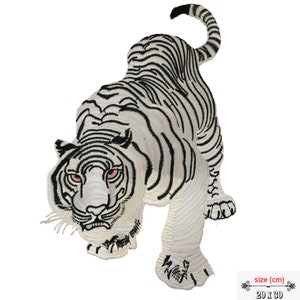 May include: White embroidered iron-on patch of a tiger with black stripes. The tiger is facing forward with its mouth open and its eyes are red. The patch is 20 inches by 30 inches.
