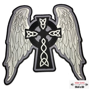 May include: A black and white embroidered patch of a Celtic cross with wings. The cross is surrounded by a circle of knots and the wings are detailed with feathers. The patch is 26.5 inches by 29 inches.