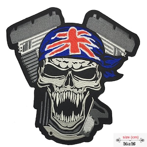 May include: Embroidered iron-on patch featuring a skull wearing a bandana with the Union Jack flag design. The skull is in front of a stylized motorcycle engine. The patch is 24 x 25 cm.