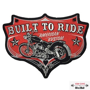 May include: Red and black embroidered patch featuring a motorcycle, stars, and the text "Built to Ride American Kustom". The patch measures 30 x 22.5 cm.
