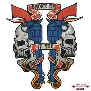 May include: Embroidered patch with two blue pistols crossed over a red, white, and blue ribbon that says "If You Got Em, Smoke Em". The pistols are surrounded by two white skulls with black eyes and mouths. The patch is 20 inches by 25 inches.