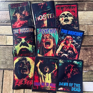 May include: Nine iron-on patches featuring horror movie themes. The patches depict various characters and titles from popular horror films, including "Wrong Turn", "Hereditary", "Hostel", "The Russian Sleep Experiment", "Psycho", "The Descent", "Evil Dead", "Drag Me To Hell", and "Dawn of the Dead".