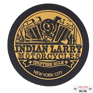 May include: A black and gold embroidered patch with the text "INDIAN LARRY MOTORCYCLES + CHOPPERS RULE + NEW YORK CITY". The patch features a stylized image of a motorcycle engine.