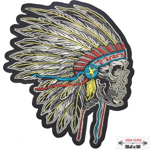 May include: Embroidered iron-on patch featuring a skull wearing a colorful Native American headdress with feathers. The patch is 22.5 inches by 25 inches.
