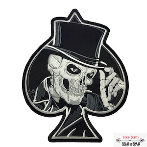 May include: Black and white embroidered iron-on patch of a skull wearing a top hat and a suit, in the shape of a spade playing card. The patch measures 22.5 cm by 27.5 cm.