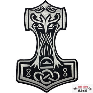 May include: A black and silver embroidered iron-on patch featuring a stylised Mjolnir hammer with a face in the head of the hammer. The hammer is surrounded by a knot design. The patch measures 16.5 x 25 cm.