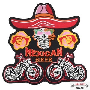 May include: Embroidered patch featuring a skull wearing a red sombrero with two pink roses on either side. The skull has green eyes and a white smile. The text "MEXICAN BIKER" is below the skull. Two black motorcycles are at the bottom of the patch. The patch is 28 inches by 29 inches.