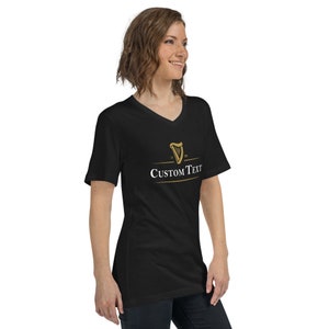 May include: Black v-neck t-shirt with a gold harp graphic and the text "CUSTOM TEXT" in white.