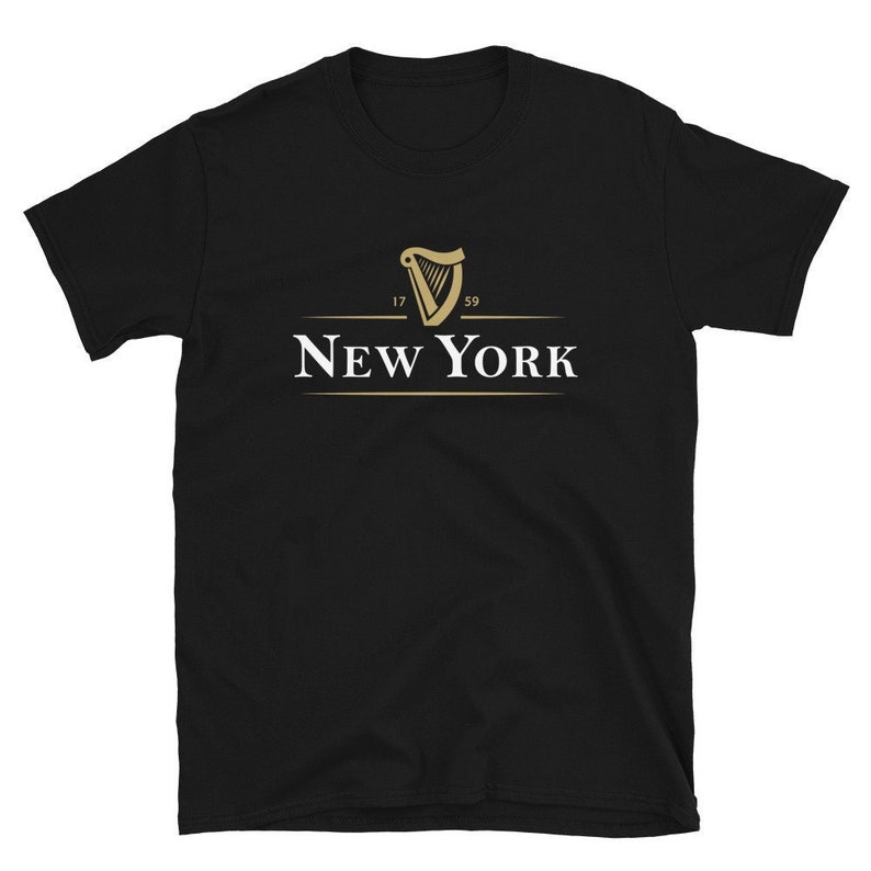 May include: Black t-shirt featuring a gold harp logo with the text "NEW YORK" underneath. The harp has the numbers "17" and "59" on either side.
