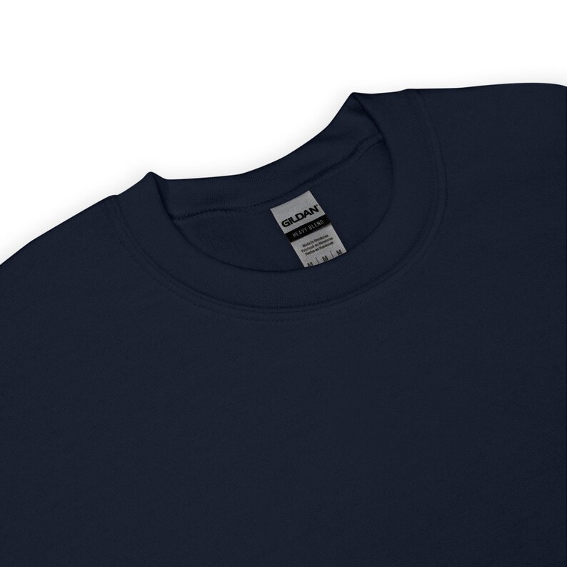 May include: A navy blue crew neck sweatshirt with a white Gildan Heavy Blend tag attached to the neckline.