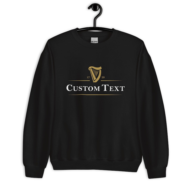 May include: Black sweatshirt with a gold harp logo and the text "CUSTOM TEXT" underneath. The harp logo has the numbers 17 and 59 on either side.