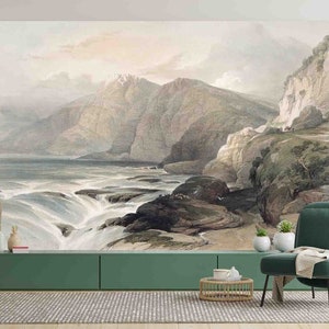 May include: A large wall mural depicting a landscape with mountains, a waterfall, and a body of water. The artwork is in muted tones of gray, blue, and green. The mural is installed in a room with a green cabinet, a green chair, and a plant.