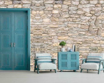 May include: A room with a stone wall, a blue double door, two blue chairs with white cushions, and a blue cabinet with a wood top.