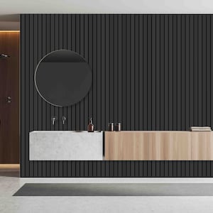 May include: A modern bathroom vanity with a black slatted wall, a round mirror, a white countertop, and a light wood cabinet with drawers.