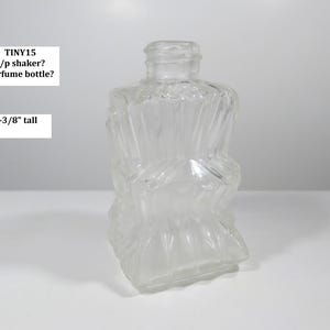 May include: A clear, textured glass bottle, approximately 2-3/8 inches tall, with a unique, twisted design. The bottle has a small opening at the top and a square base. Text on the image reads: TINY15 s/p shaker? perfume bottle?
