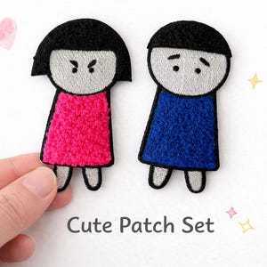 May include: Set of two embroidered patches featuring cartoon figures with black hair and outfits in pink and blue. The patches have a simple design with embroidered details and the text "Cute Patch Set".