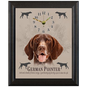 May include: A framed clock featuring a brown and white German Shorthaired Pointer dog's face in the centre. The clock face has black Roman numerals and a gold-coloured hour and minute hand. The text "GERMAN POINTER" is below the dog's face, and the text "Sleek and a bundle of intense energy, a good hunting dog but they expect to share the sofa" is below the text "GERMAN POINTER".