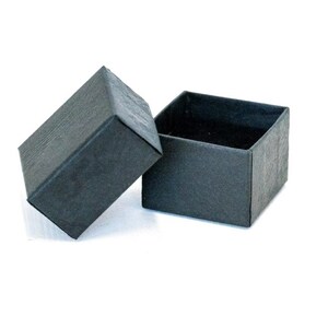 May include: A black, open square box with a textured finish. The lid is ajar, showing the dark interior. The box is suitable for jewellery or small gifts.