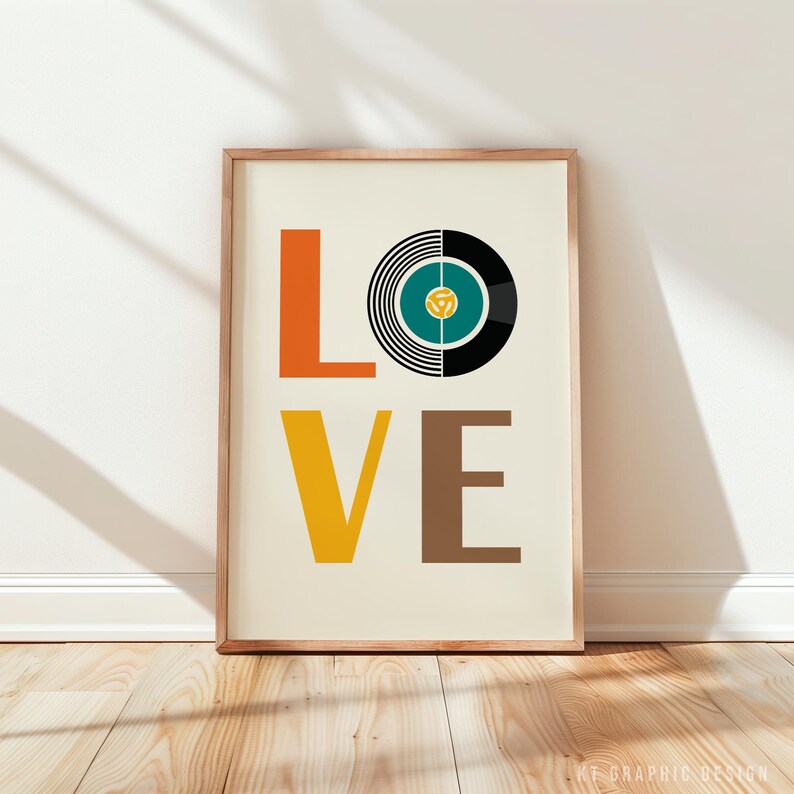 May include: A framed art print with the word "LOVE" in bold, colorful letters. The "O" is replaced with a vinyl record design in black, teal, and white. The print is in a wooden frame.