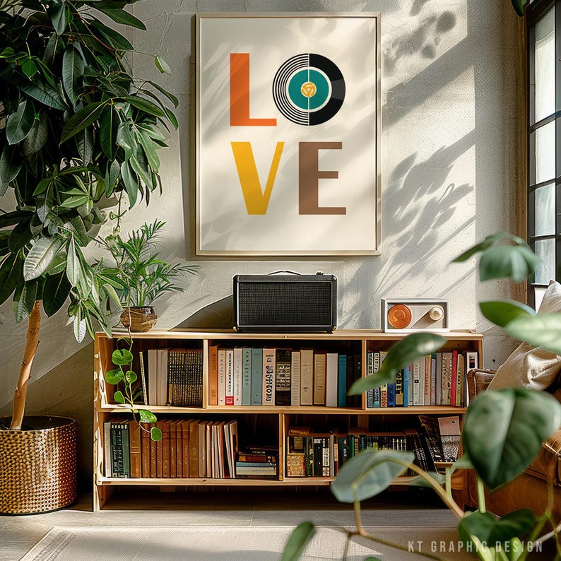 May include: A framed print with the word "LOVE" in orange, yellow, and brown block letters, with a vinyl record graphic replacing the "O". A wooden bookshelf with books and a speaker are below the print. Plants are in the foreground.