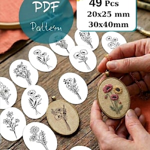 May include: A collection of 49 pieces featuring floral line art patterns in 20x25 mm and 30x40 mm sizes. The set includes oval-shaped embroidery designs on white paper and a finished oval pendant with embroidered pink and yellow flowers.