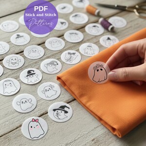 Pode incluir: Uma coleção de padrões brancos, circulares, de colar e costurar com vários desenhos de fantasmas. A imagem inclui um tecido laranja e o texto "PDF Stick and Stitch Patterns". Uma mão segura um dos padrões de fantasmas.