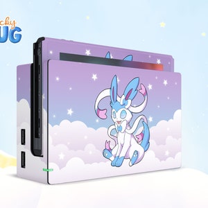 May include: A purple and blue Nintendo Switch console skin with a white and blue cartoon character with stars and clouds in the background. The text "Sticky HUG" is in the top left corner.