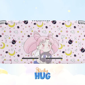 May include: Pink and white Nintendo Switch case with a Sailor Moon character and a black cat. The case has a repeating pattern of stars, moons, and rabbits.