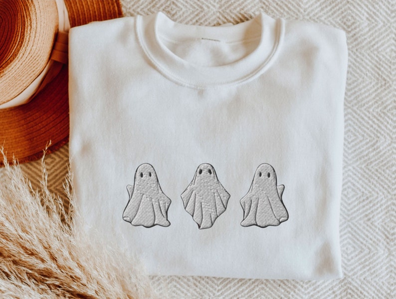 May include: White sweatshirt with three embroidered gray ghosts.