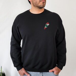 May include: Black long-sleeve sweatshirt with an embroidered outline of Lebanon with the Lebanese flag colors on the left chest.