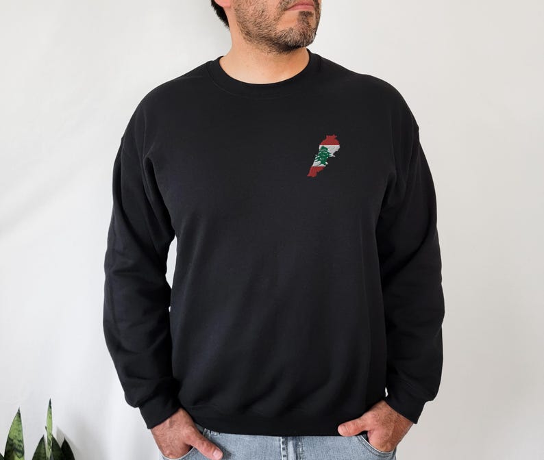 May include: Black long-sleeve sweatshirt with an embroidered outline of Lebanon with the Lebanese flag colors on the left chest.