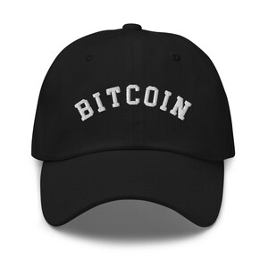 May include: Black baseball cap with white embroidered text that reads "BITCOIN" in an arched font.