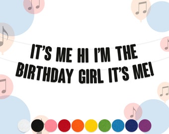 May include: Black and white banner with the text "It's Me Hi I'm The Birthday Girl It's Me!"  The banner is strung with white string and has black circles on the bottom.