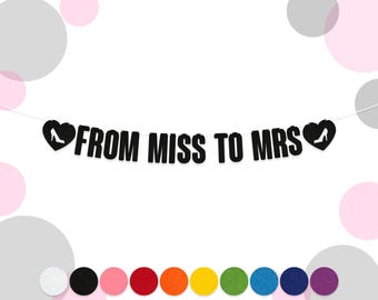 May include: Black and white banner with the text "From Miss to Mrs" and a small white shoe icon in each heart at the ends of the banner.