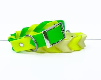 May include: A neon green and yellow dog collar with a silver buckle and D-ring. The collar is made of braided material in shades of green and yellow. The buckle is silver and the collar is set against a white background.