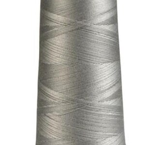 May include: A spool of silver gray thread with the label "Maxi-Lock" on the top.