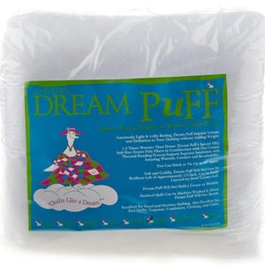 May include: White Dream Puff batting for quilting, packaged in a clear plastic bag. The bag features a cartoon goose with a quilt and the text "Quilts Like a Dream". The product description highlights its lightweight, lofty, and warm properties, as well as its ability to add volume and definition to quilts.