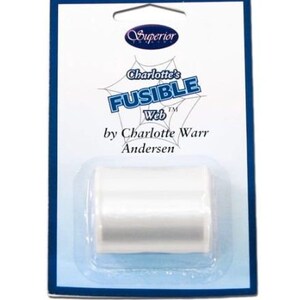 May include: A white spool of Charlotte's Fusible Web by Charlotte Warr Andersen, a product for crafting and sewing.