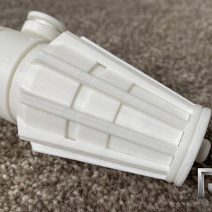 May include: White plastic lightsaber hilt with a detailed, segmented, cylindrical end cap.