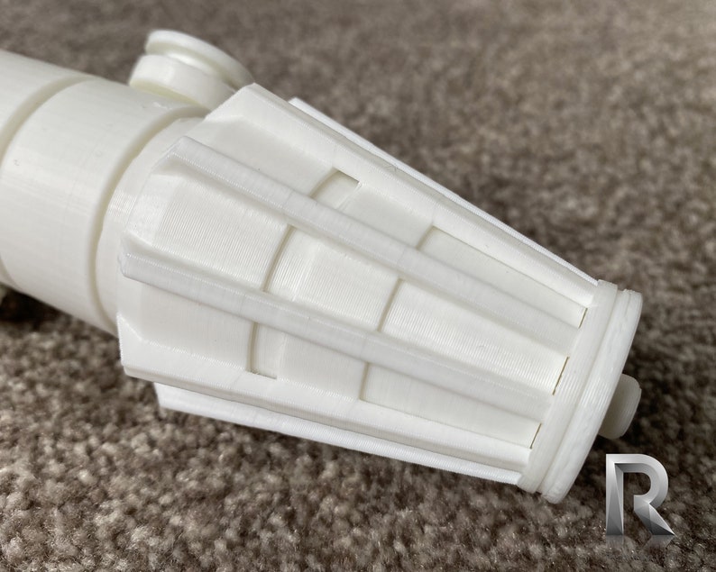 May include: White plastic lightsaber hilt with a detailed, segmented, cylindrical end cap.