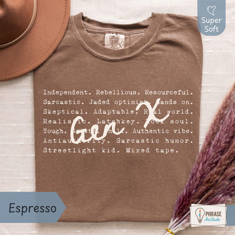 Comfort Colors Gen X humor tshirt in espresso brown featuring satirical Gen X traits in a typewriter-style font with handwritten “Gen X” overlay. Perfect gift for Generation X adults who love sarcastic humor, retro 80s 90s nostalgia, and vintage-inspired designs. Photographed flat lay with hat and dried flowers on neutral fabric background. Soft cotton unisex tee ideal for casual wear, birthdays, or everyday comfort with a touch of attitude.