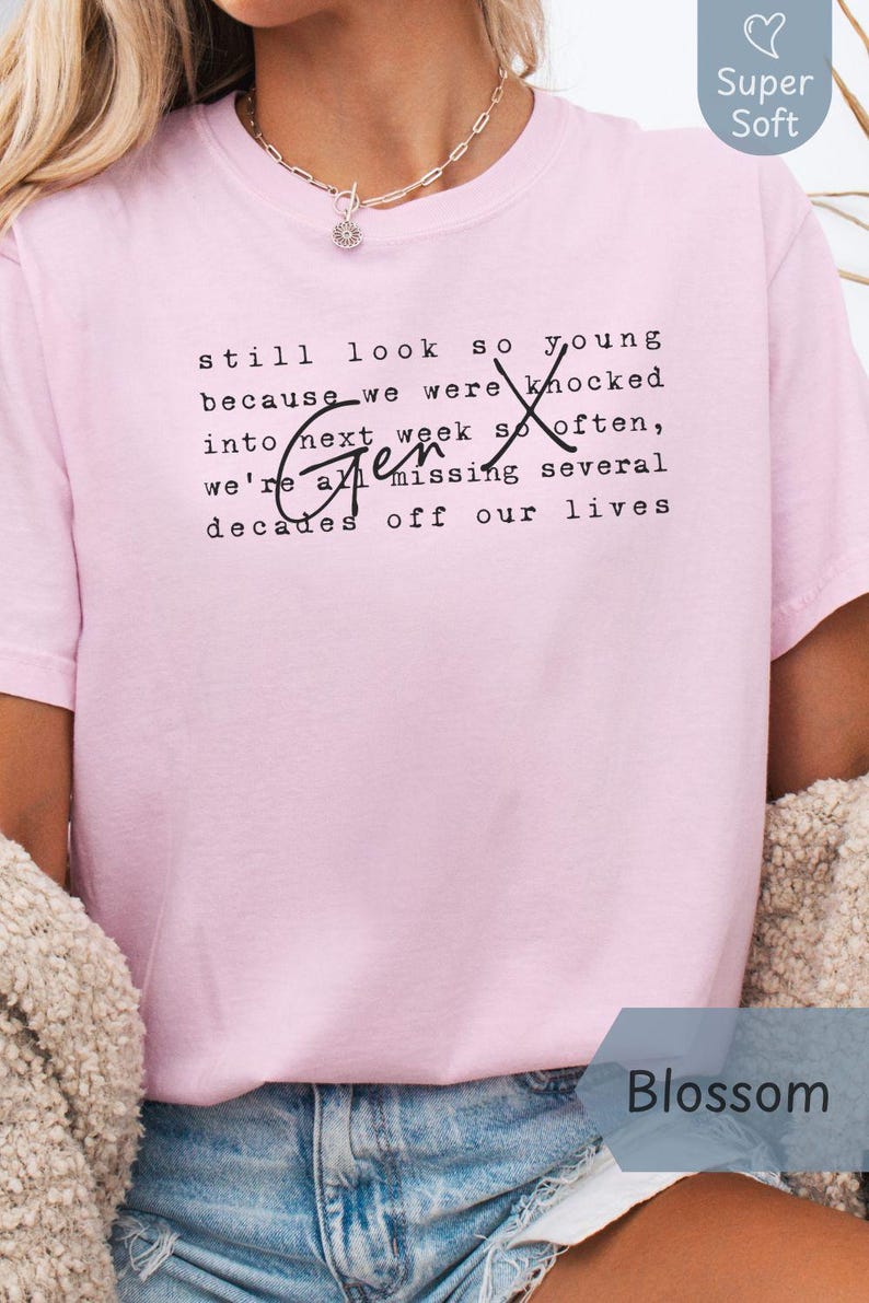 Lifestyle photo of a person wearing a super soft Comfort Colors “Blossom” pink tee with Gen X quote text in typewriter font and script “Gen X.” Styled with denim shorts, a cozy cardigan, and a necklace for casual everyday wear. Funny Gen X nostalgia shirt for coffee runs, errands, birthdays, reunions, and 90s throwback days - designed by PhraseArtStudio, Still Kickin Club.