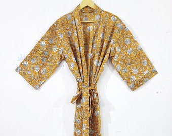 May include: A long yellow robe with a white floral pattern. The robe has a tie belt and long sleeves.