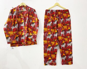 May include: Red pajama set with a white zebra, leopard, and bird print. The top has a button-up front and long sleeves. The pants have an elastic waistband.